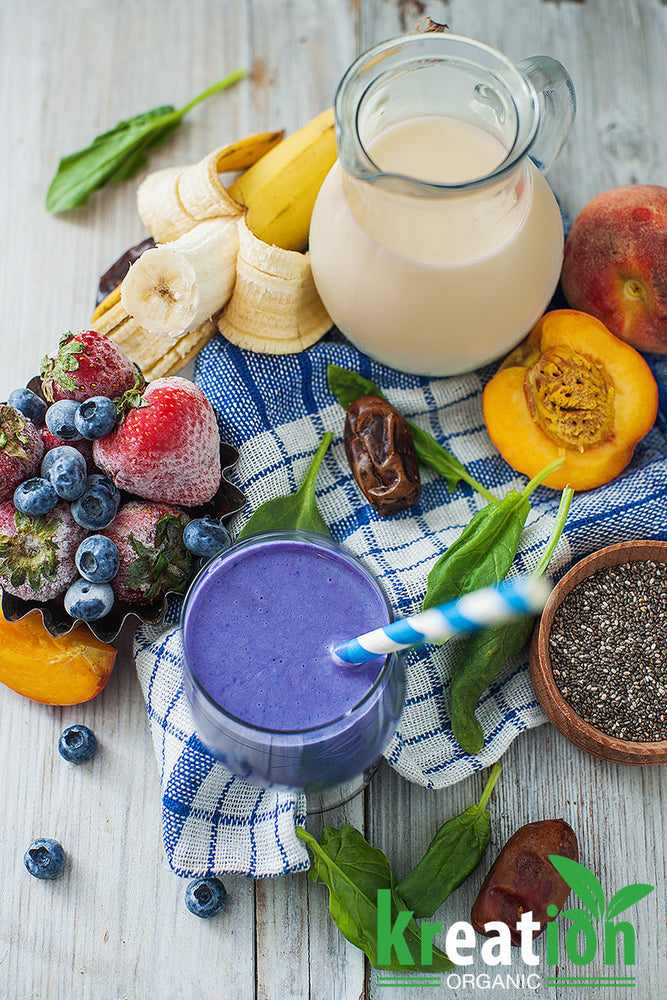 a blue kreation drink surrounded by fruits